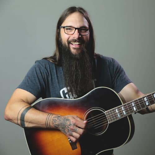 Tony Polecastro playing an acoustic guitar
